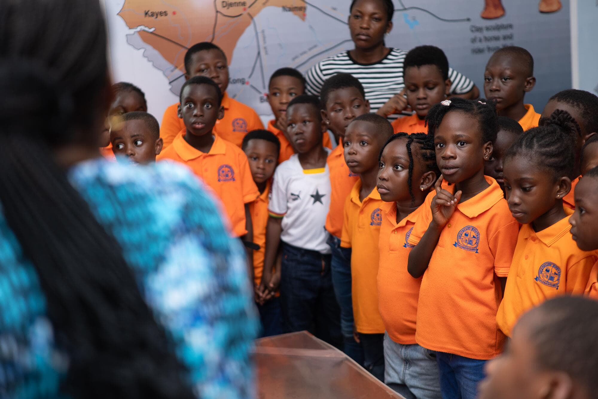 Pupils looking closely at a map exhibit at the Ghana National Museum
