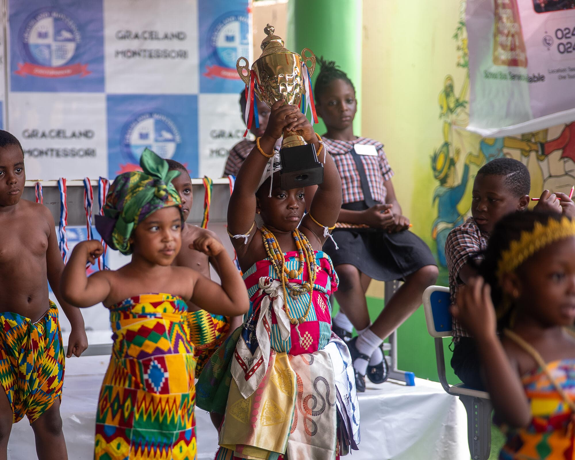 A young Graceland pupil raising the competition trophy overhead