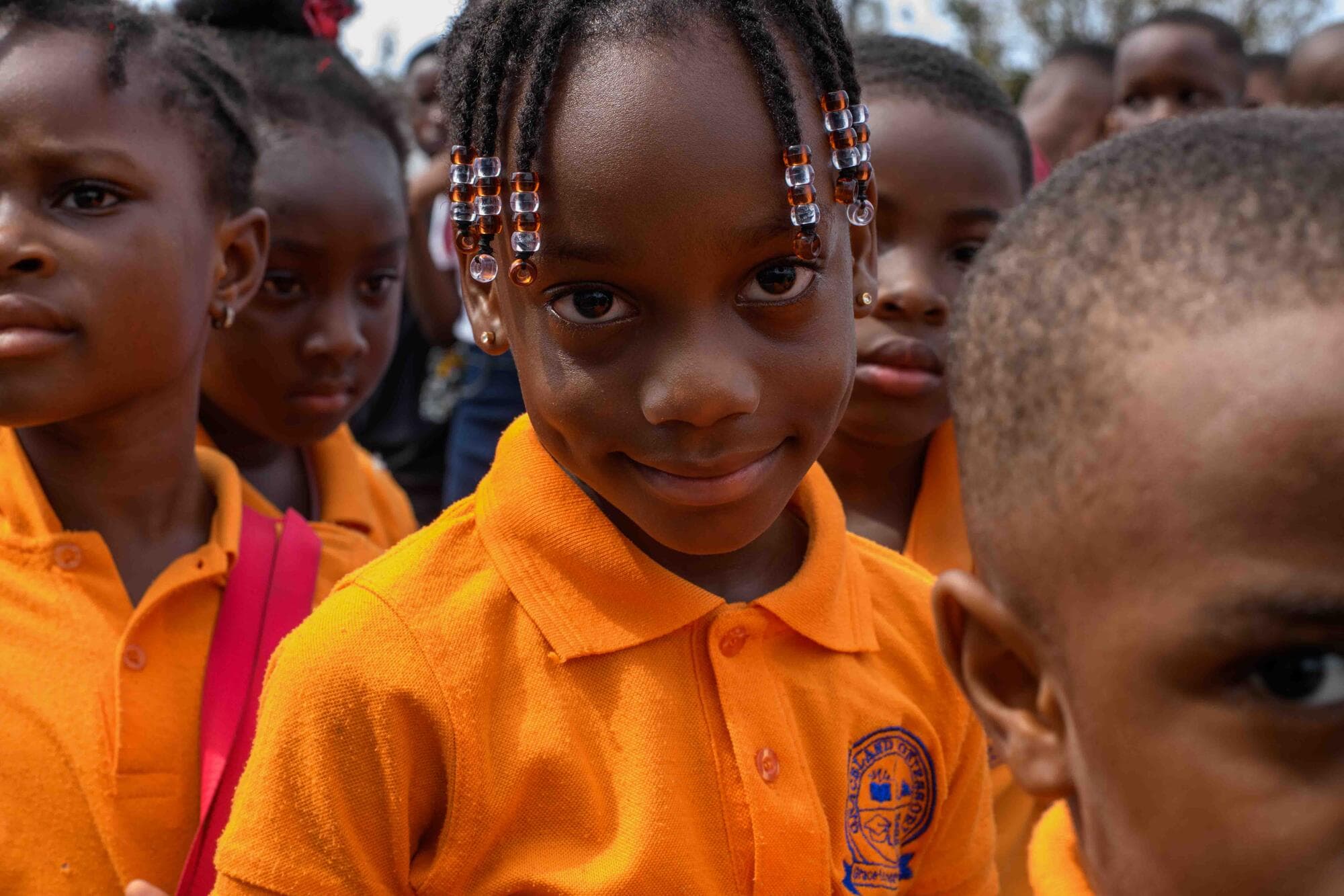 Close-up of a smiling Graceland pupil among her classmates