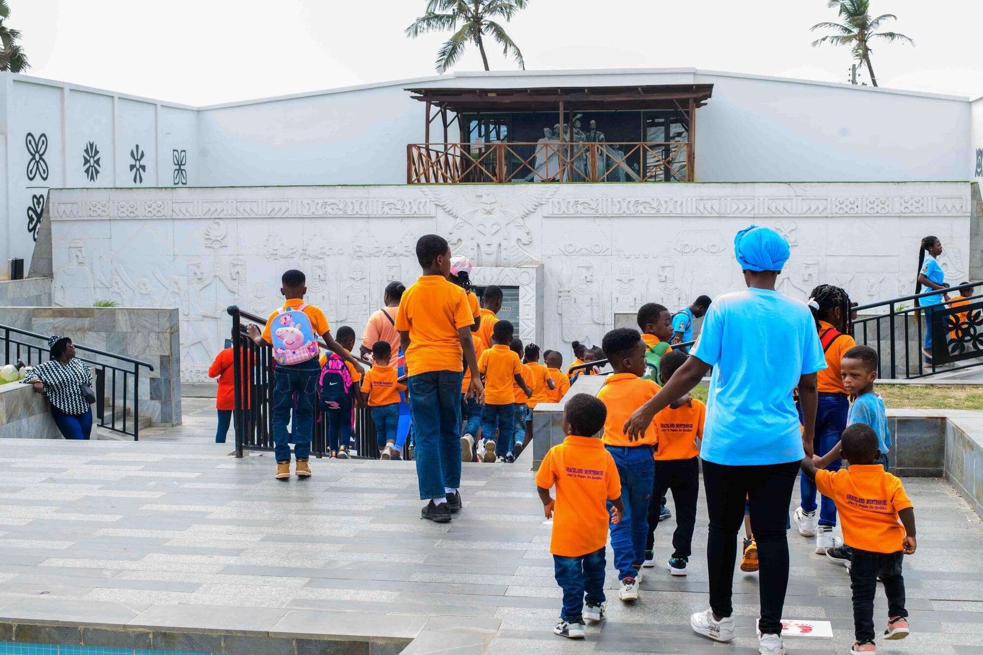 Pupils walking up the steps toward the memorial building