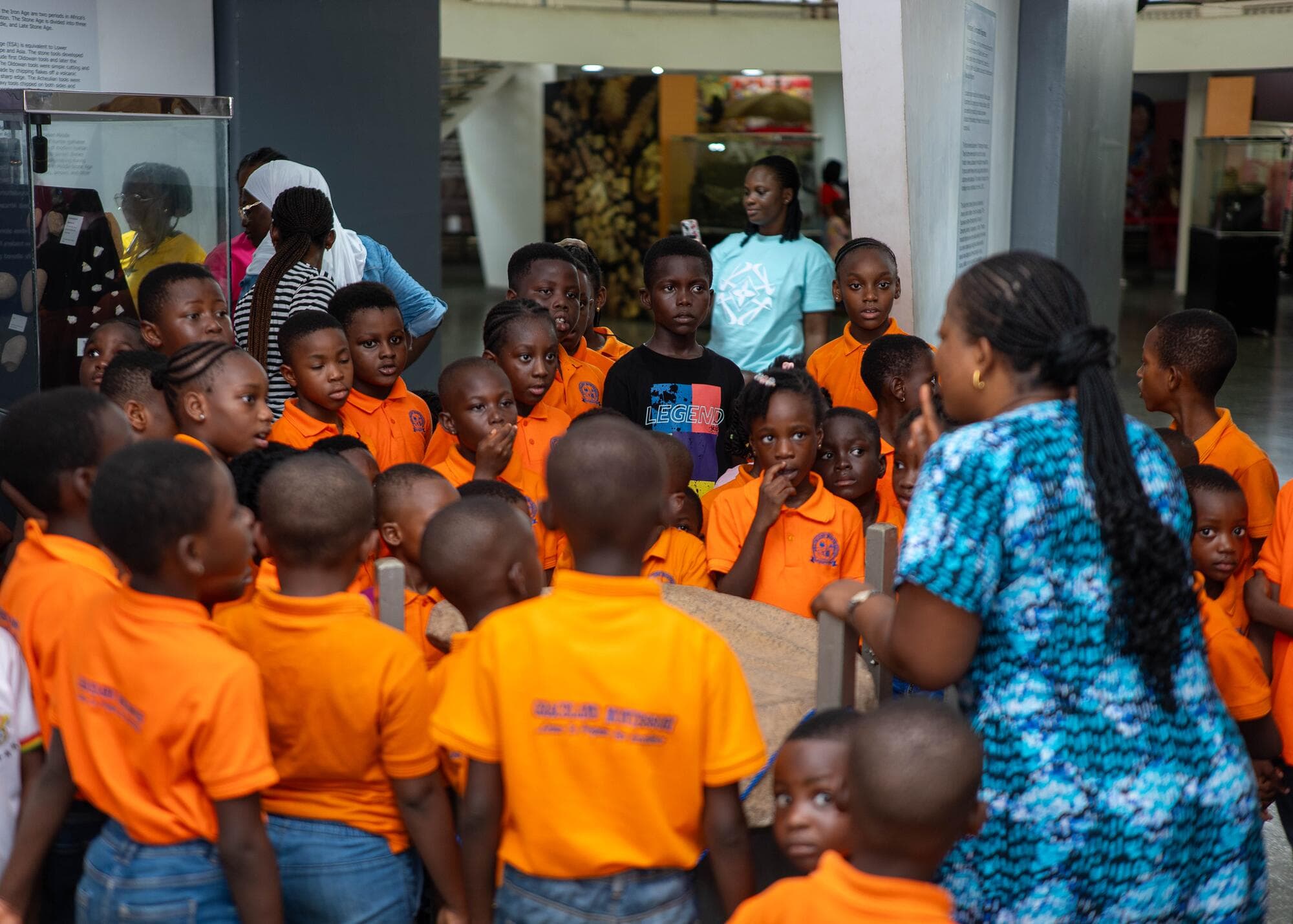 The group listening to a guide inside the Ghana National Museum's main hall