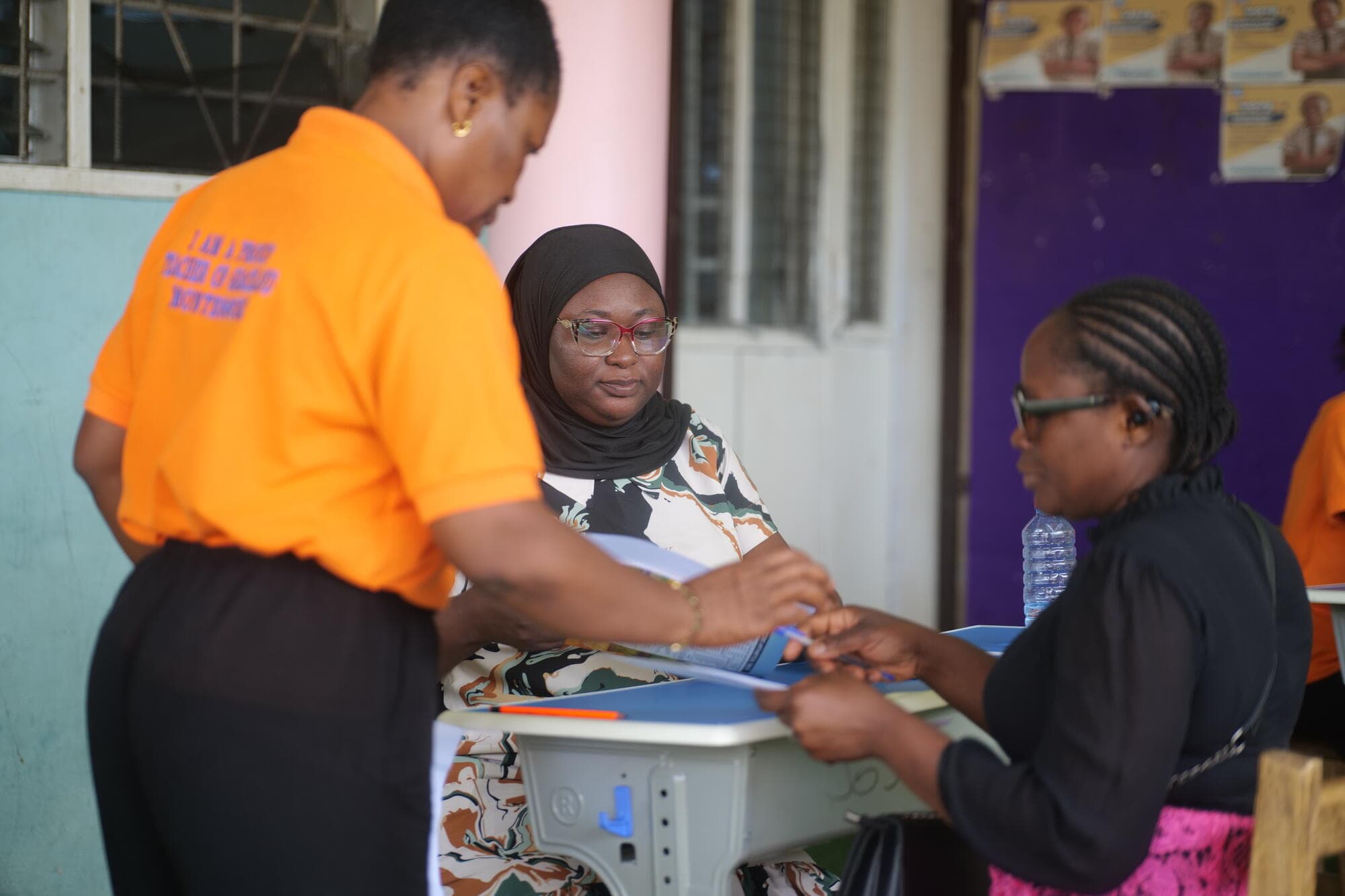 Staff reviewing a report with a parent at a desk